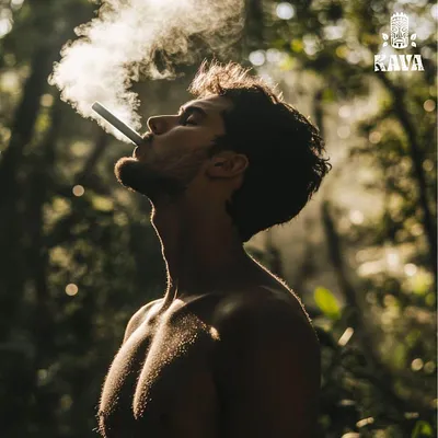 Man exhaling vapor in the forest with the Wild Orchard Kava logo